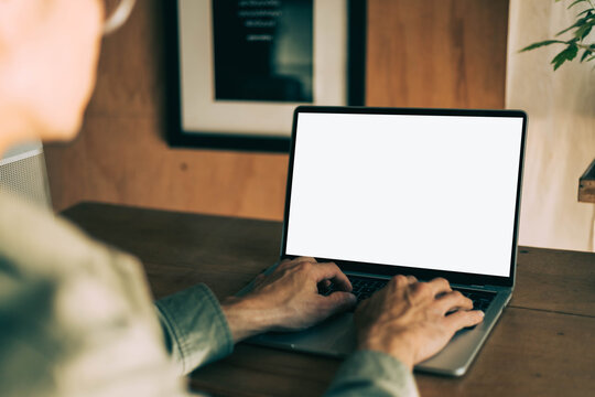 computer screen blank mockup.work using laptop with white background for advertising,contact business search information on desk at coffee shop.marketing and creative design
