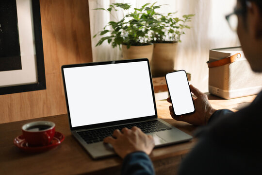 computer screen,mobile phone blank mockup.work using laptop texting cell phone.white background for advertising,contact business search information on desk.marketing,design