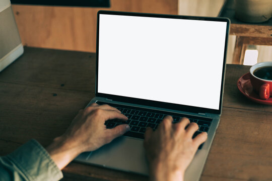 computer screen blank mockup.work using laptop with white background for advertising,contact business search information on desk at coffee shop.marketing and creative design