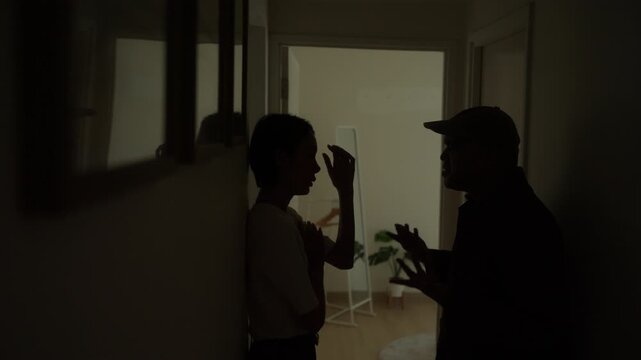 Stressed couple arguing at home over family and financial problems. Relationship conflict, emotional distance debt. Economic pressure  communication issues and debt. Mental health and marriage.
