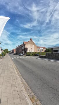 Vertical walking hyperlapse along Legeweg street, Sint-Andries, Bruges, Belgium