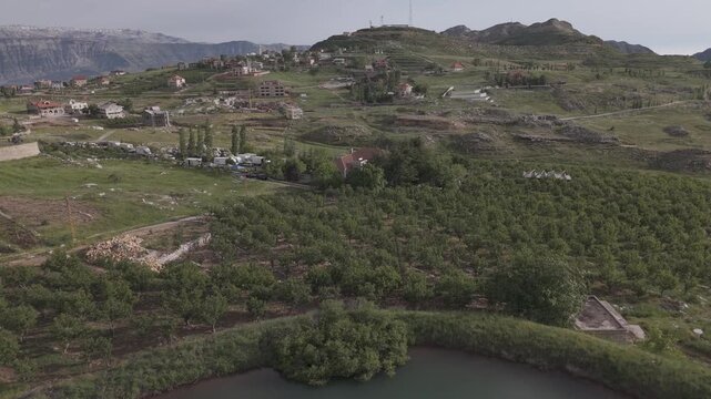 Akoura Mount Lebanon Mountain Lake and Green Orchards Village Panorama Forward Reveal Flyover Cinematic Aerial Drone Shot DJI Raw Not Color Graded