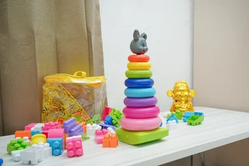 Fotobehang Lego Colorful children's stacking toy with building blocks and decorative figurine  © Ibenk.88