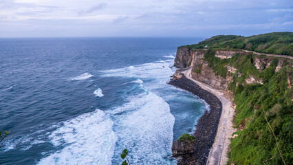 Fototapeta premium Dramatic Coastal Cliffs with Ocean Waves and Curved Path