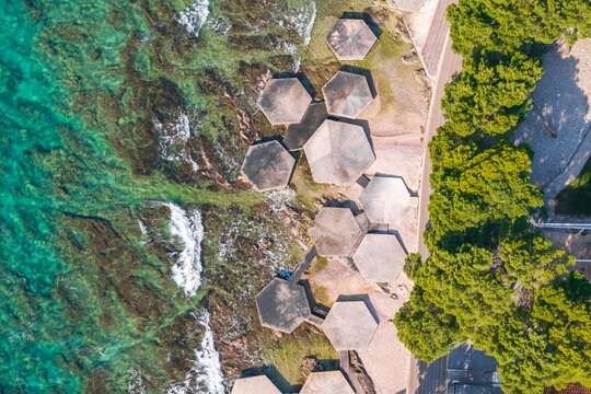 Top-down aerial view of the Adriatic coastline and hexagonal sea platforms in Vodice, Croatia
