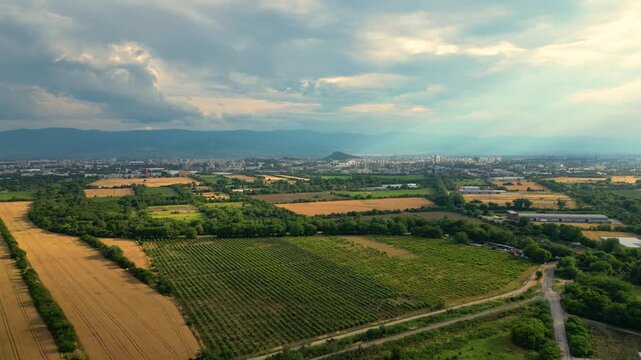 Aerial View of Farmland and Plovdiv City beneath Dramatic Clouds and Rhodope Mountains, Bulgaria