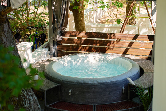 Inflatable hot tub with bubbling water on outdoor terrace
