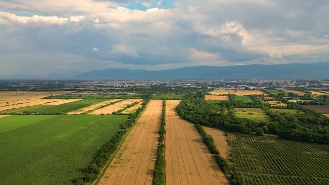 Aerial View of Agricultural Fields near Plovdiv with City Skyline and Rhodope Mountains, Bulgaria