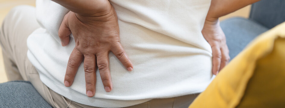 Older woman feeling back pain at home