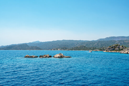Turquoise waters and ancient Lycian coast of Kekova Island during a boat cruise in Antalya, Turkey.