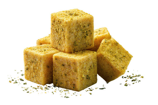 Stacked seasoned bouillon cubes with herbs isolated on transparent background for cooking and food photography