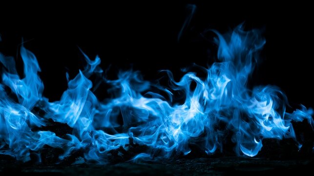 Dynamic blue flames burning on dark black background with glowing heat, energy, fire texture and intense motion creating a dramatic abstract combustion concept
