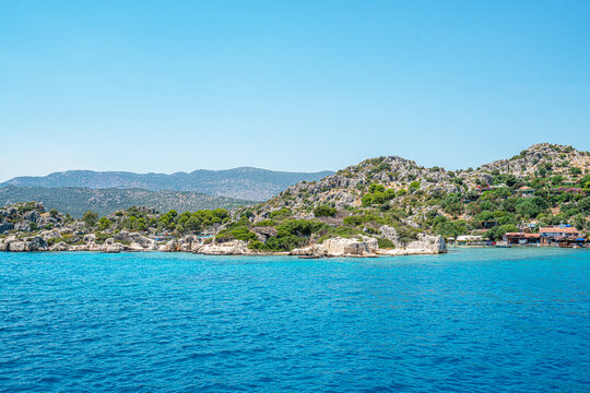 Turquoise waters and ancient Lycian coast of Kekova Island during a boat cruise in Antalya, Turkey.