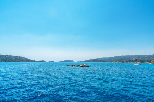Turquoise waters and ancient Lycian coast of Kekova Island during a boat cruise in Antalya, Turkey.