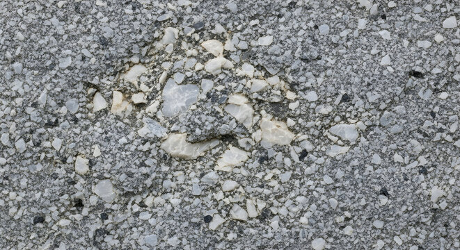 Rough grey and white stone texture background with small and large aggregate particles