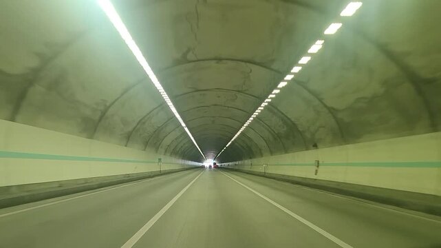 POV Driving View Inside a Highway Tunnel with Lights