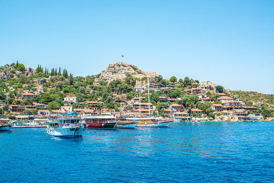 Turquoise waters and ancient Lycian coast of Kekova Island during a boat cruise in Antalya, Turkey.