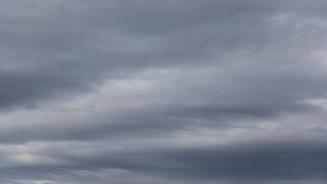 Natural backgrounds and textures. A striking background of gray stratus clouds.