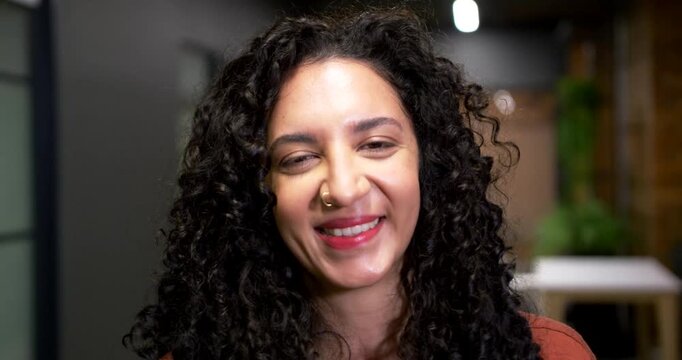 African American woman reacting to camera prompt smiling widening grin showing nose ring in studio