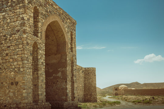 A grand historic perspective featuring two iconic caravanserais in Ahouan, Semnan Province, Iran.