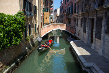 Traditional gondola ride on the narrow water canal, tourist in Venice © Miroslawa Drozdowski