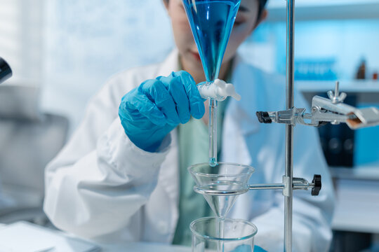 Scientists analyze liquid samples using test tubes, microscopes, and laboratory equipment, representing biotechnology, medical diagnostics, research, and healthcare innovation.