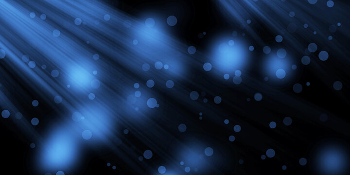 Blue light rays stream with floating bokeh circles across a dark empty background