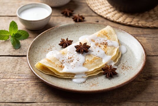 Somali Malawah Sweet Crepe Drizzled with Coconut Milk and Garnished with Fragrant Star Anise
