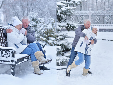 Happy elderly couple playing in snowy winter garden