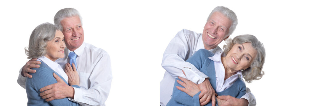 Happy senior couple embracing and smiling on white background