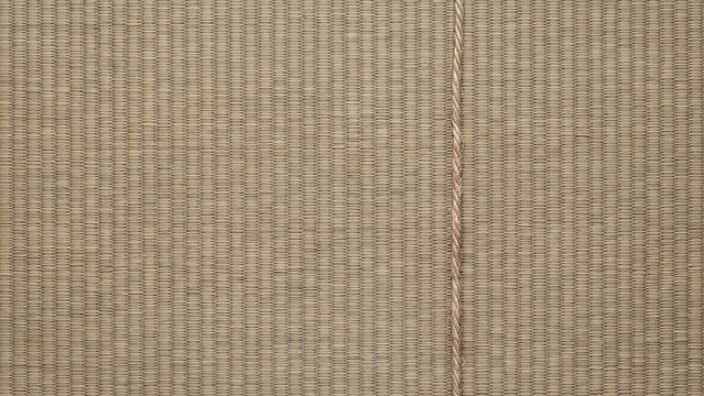 Vertical natural twine string on a woven grass mat texture background with copy space
