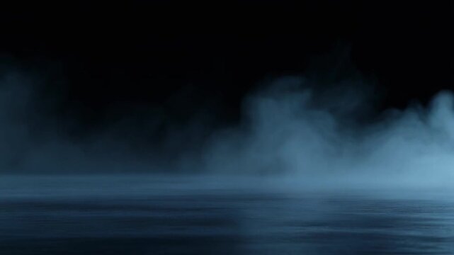 Deep indigo fog rolls slowly across dark reflective surface, gentle billows continuously shifting under cool backlighting with moody serene atmosphere, soft glow, and cinematic depth.