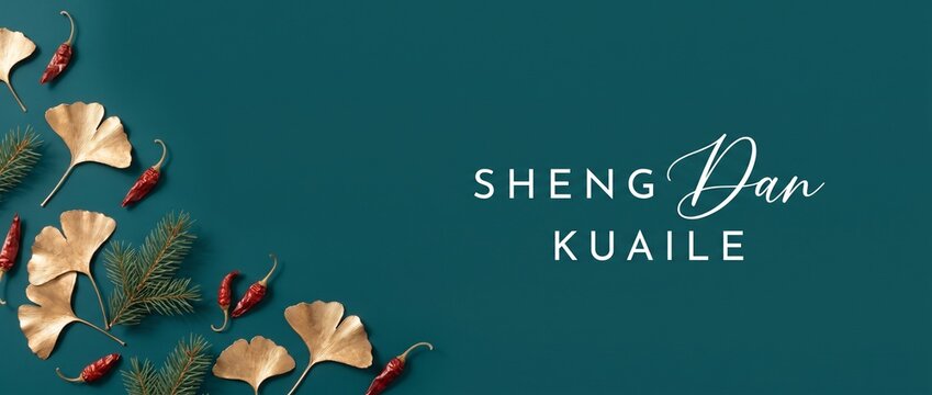 Chinese Merry Christmas Background Banner featuring Sheng Dan Kuai Le typography text with golden ginkgo leaves, red chili peppers, pine branches on dark teal flat lay frame for Asian holiday design