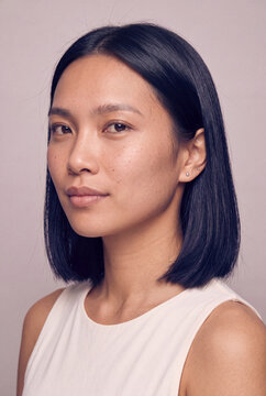 Studio headshot of asian woman with bob haircut and neutral makeup for beauty profile portrait and personal branding use