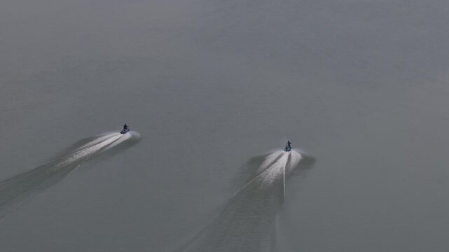 Aerial close up of jet skiers on Snake River Burley Idaho with hazy sky