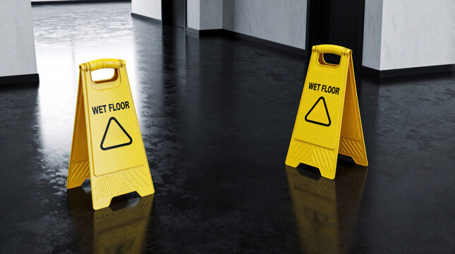 Yellow wet floor signs stand on a shiny dark floor in a building hallway. These caution symbols warn people about slippery surfaces. Safety precaution for cleaners maintenance staff building managers.