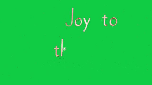 Initial pink spark bursting and drawing Joy to World revealing title on transparent background