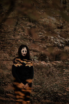 Spooky and scary Halloween themed image in a dark forest. 