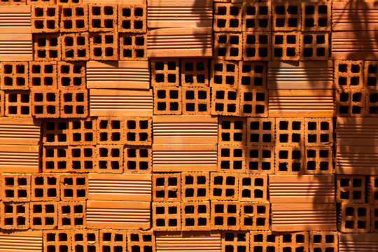 Stacked Perforated Clay Bricks with Dense Repeating Hole Pattern