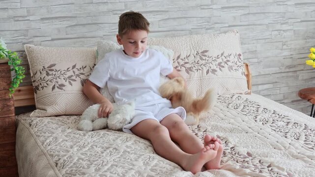 Cute preschool child, boy, playing with toys in a sunny living room
