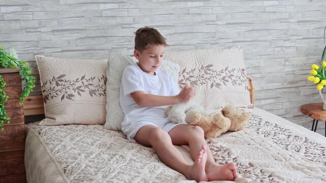 Cute preschool child, boy, playing with toys in a sunny living room