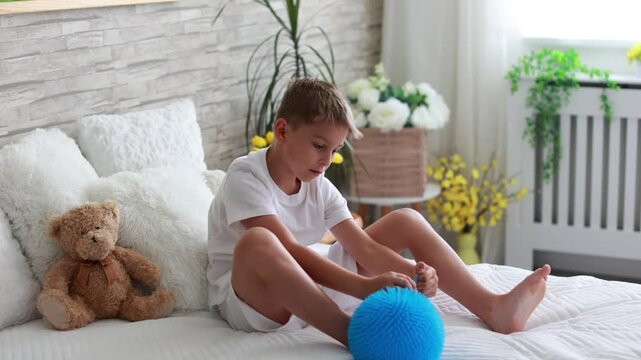 Cute preschool child, boy, playing with toys in a sunny living room