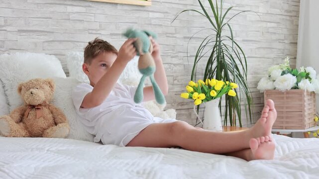 Cute preschool child, boy, playing with toys in a sunny living room