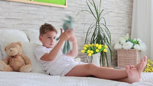 Cute preschool child, boy, playing with toys in a sunny living room