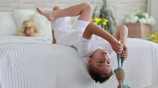 Cute preschool child, boy, playing with toys in a sunny living room