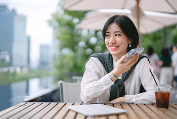 Obraz premium Freelance business adult woman modern lifestyles in downtown relax at outdoor terrace of cafe with coffee drink