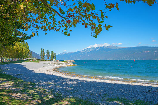 beautiful bathing area Toscolano. gravel beach, view to Monte Baldo mountain. italy resort
