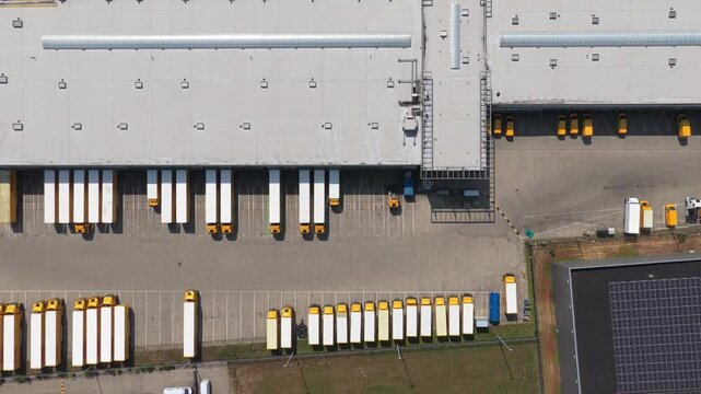Aerial view of delivery vans parked at a logistics center
