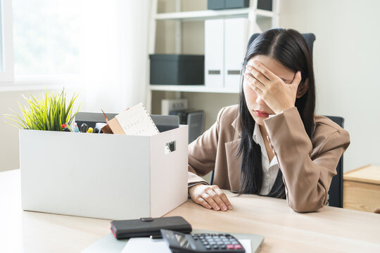 Unemployed, quite job, desperate asian young businesswoman resigning from company packing belongings, stuff in box cardboard, layoff or leaving, changing work. Resignation employment, dismiss concept.