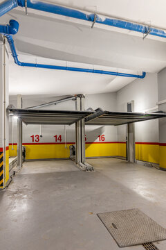 Underground Parking Garage with Elevated Double Car Lift Platforms. Hydraulic Mechanical Vehicle Stacker for Space Saving Storage